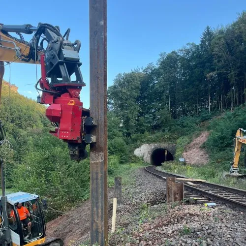 Rammgerät an einem Bahngleis vor einem Tunnel